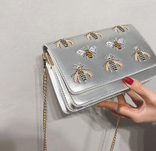 silver bag sling bag with bugs insects edgability angle view