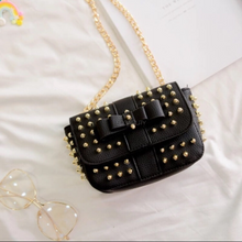 black bag studded bag with gold rivets edgability top view