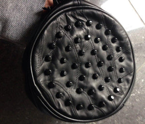 studded black round bag with tassels edgability front view