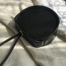 black flat round croc skin box bag edgability top view
