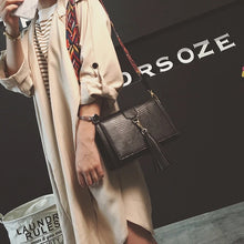 snakeskin bag black bag sling bag with tassels edgability model view