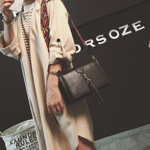 snakeskin bag black bag sling bag with tassels edgability model view