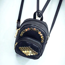gold studs on black mini backpack top view edgability