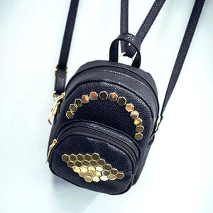 gold studs on black mini backpack top view edgability