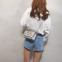 silver bag sling bag with bugs insects edgability model view