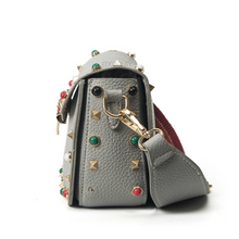 multi coloured studded sling bag side view edgability