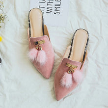 fur tassles on pink flats top view edgability