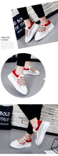 red white sneakers with hands edgability detail view