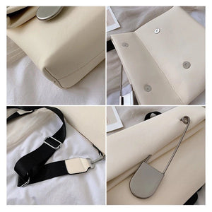 white clutch bag with safety pin edgability detail view