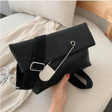 black clutch bag with safety pin edgability model view