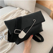 black clutch bag with safety pin edgability model view