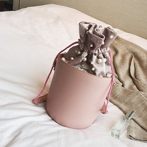 pink studded bag bucket bag drawstring bag edgability angle view