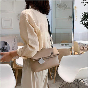 beige clutch bag with safety pin edgability model view