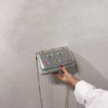 silver bag sling bag with bugs insects edgability front view