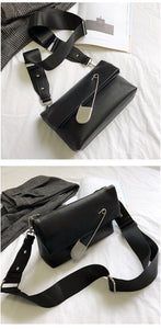 black clutch bag with safety pin edgability top view