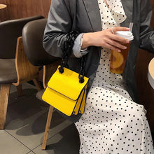 croc skin yellow sling bag with black strap edgability front view
