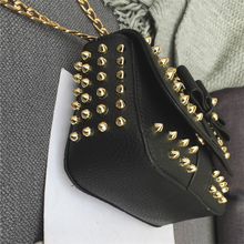black bag studded bag with gold rivets edgability side view