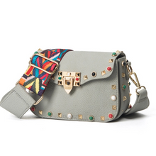 multi coloured studded sling bag angle view edgability