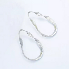 curved silver earrings silver jewelry edgability top view