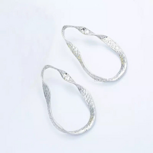curved silver earrings silver jewelry edgability top view