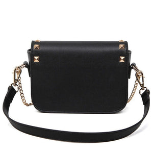 black and beige handbag with gold studs back view edgability