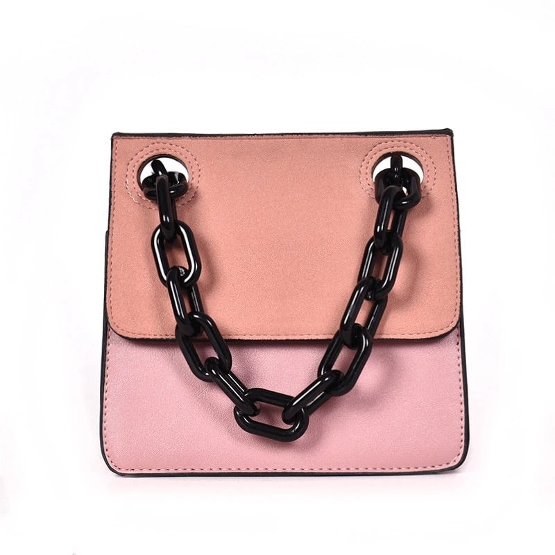 pink monotoned bag with black chain straps handle edgability