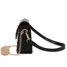 black and beige handbag with gold studs side view edgability