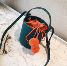 pom pom teal bucket bag edgability top view