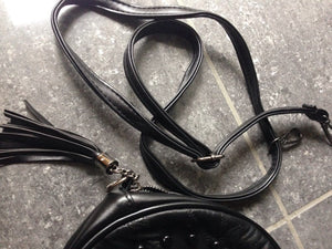 studded black round bag with tassels edgability detail view