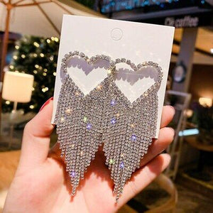 crystal studded heart shaped earrings with rhinestone tassels front view