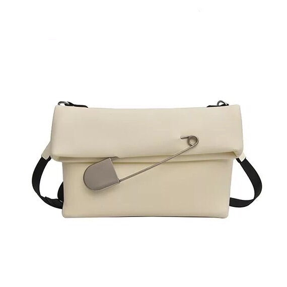 white clutch bag with safety pin edgability