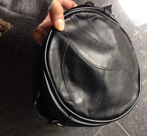 studded black round bag with tassels edgability back view