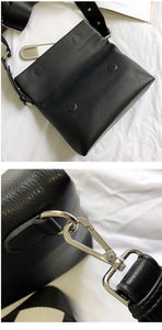 black clutch bag with safety pin edgability detail view